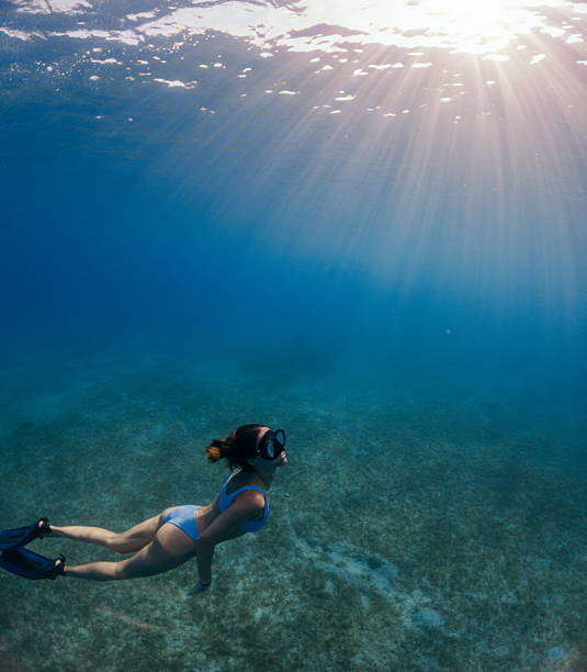 istock Beautiful woman diving underwater 2215697510