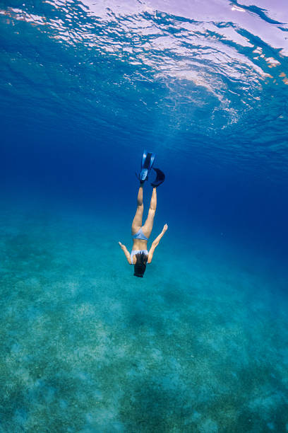 istock Beautiful woman diving underwater 2215697525