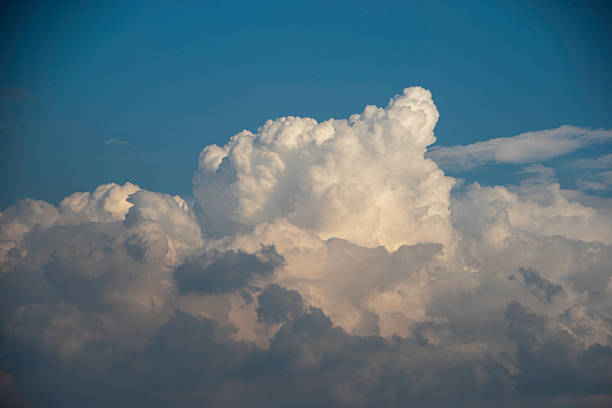 istock Photograph, a bright blue sky adorned with towering white cumulonimbus clouds. 2215700177