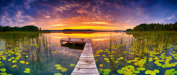 istock Beautiful summer sunrise over lake - Panorama 2215700339