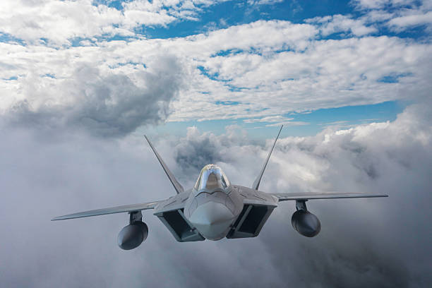 istock F-22 jet aircraft flying over clouds. 2215702579