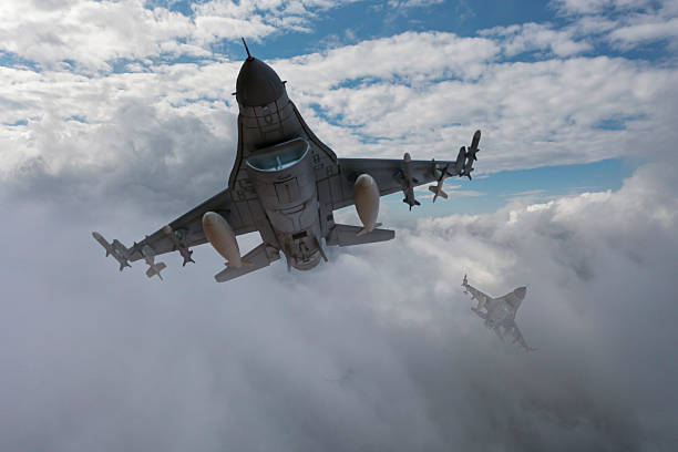 istock F-16 jet aircrafts flying over clouds. 2215702744