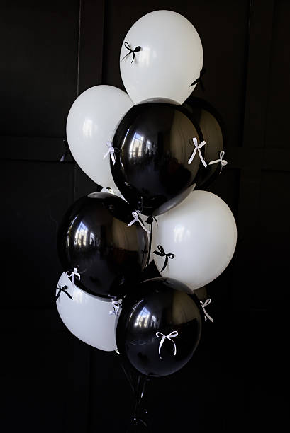 istock Black and white balloons tied with ribbons 2215702784