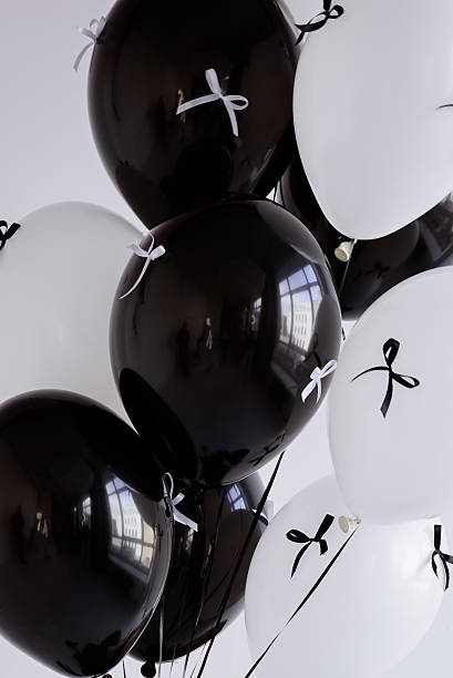 istock Black and white balloons tied with ribbons 2215702785