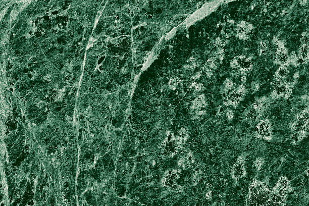 istock Real closeup of dark green marble stone texture surface background. Design pattern with high resolution for luxury home decoration. Abstract matt slab rock material. Front view of natural tiles stone surface. 2215705377