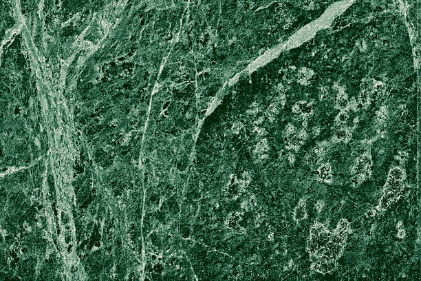 istock Real closeup of dark green marble stone texture surface background. Design pattern with high resolution for luxury home decoration. Abstract matt slab rock material. Front view of natural tiles stone surface. 2215705492
