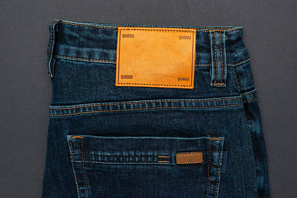 Denim Jeans with Blank Leather Label on Dark Background