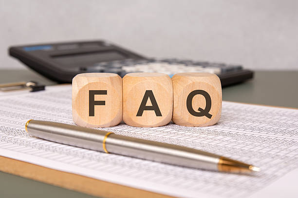 istock Wooden cubes with FAQ text on financial document, calculator and pen in background 2215711676