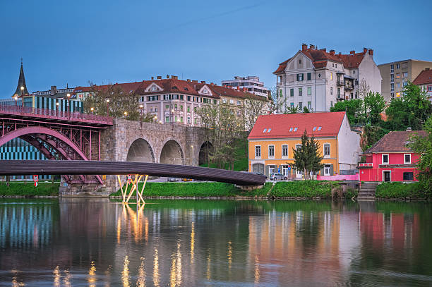 istock Spring evening by the Drava River with illuminated bridge in Maribor - Slovenia 2215711780