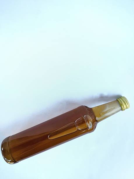 istock Honey in a glass bottle on a white background 2215712688