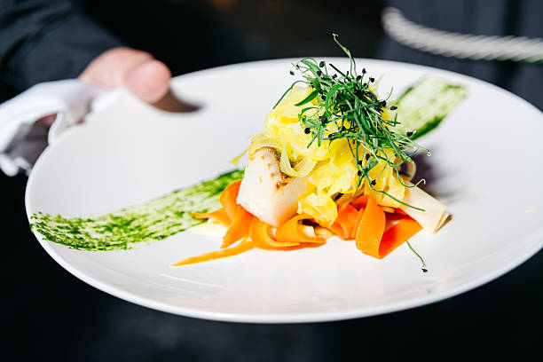 Gourmet seafood dish with vegetables garnish.