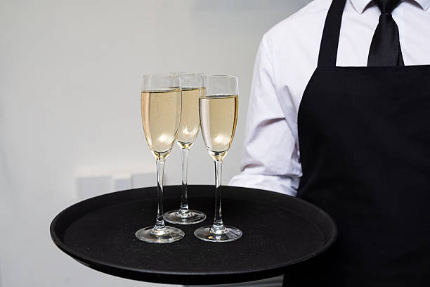 istock Waiter Serving Champagne on Elegant Tray. 2215720414