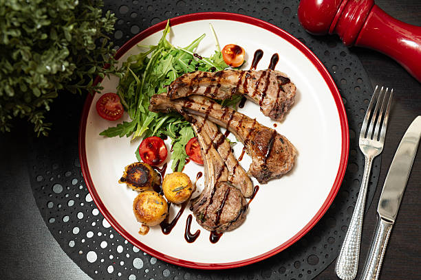 istock Grilled Lamb Chops with Vegetables and Sauce. 2215720683