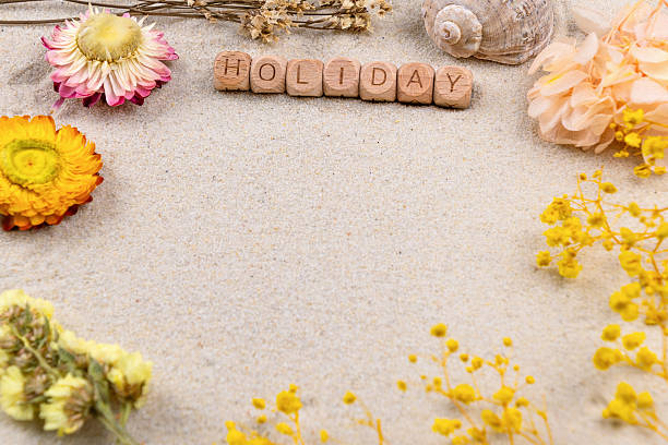 istock Holiday concept with flowers and shell on sandy background 2215724000