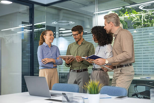 Startup business team on meeting in modern bright office interior and working on laptop.