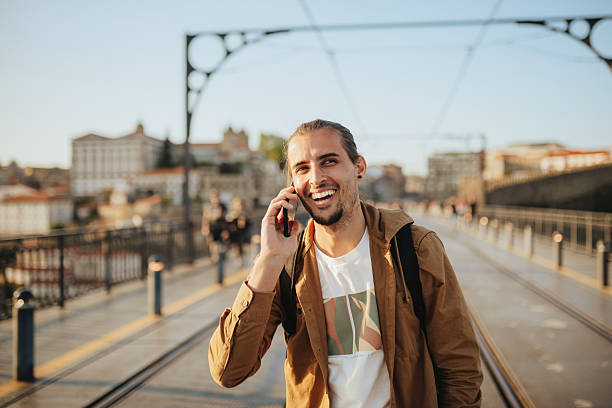 istock Man using a smart phone on the famous Porto bridge. 2215725555