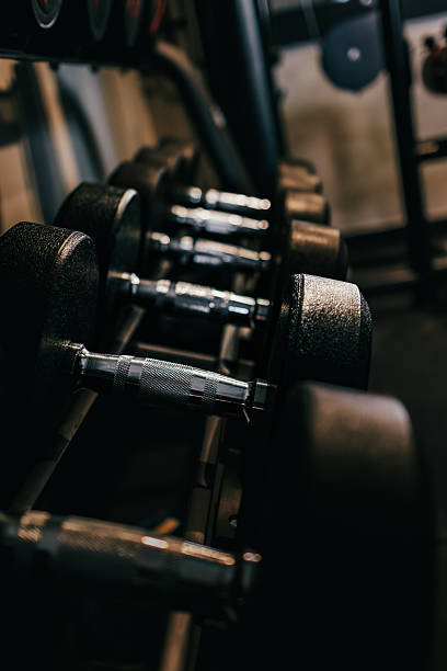 istock Dumbbells arranged on the rack in the gym. 2215725581
