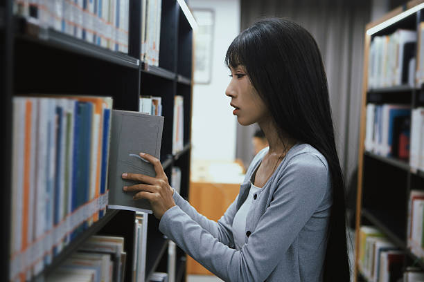 istock The girl is reading in the library 2215725813