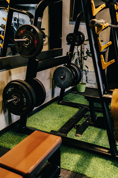 istock Wights and barbells arranged on racks in the gym. Exercise equipment ready for training. 2215725832