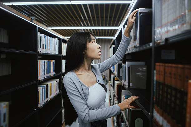 istock The girl is reading in the library 2215726005