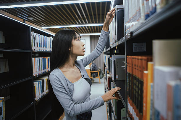 istock The girl is reading in the library 2215726138