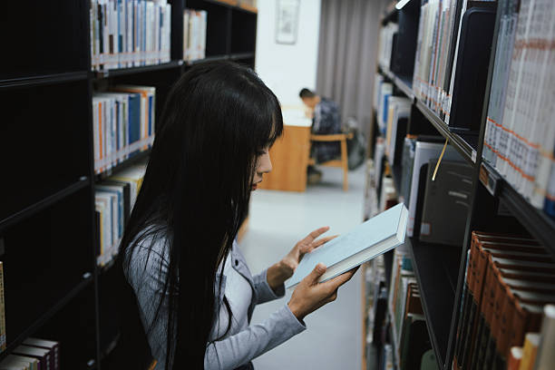 The girl is reading in the library