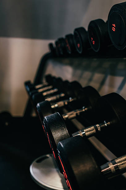 istock Dumbbells arranged on the rack in the gym. 2215726441