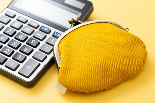 istock Calculator and wallet on a yellow background. 2215727549
