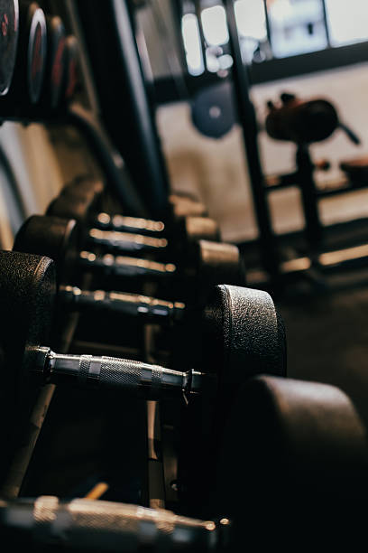 istock Dumbbells arranged on the rack in the gym. 2215728864