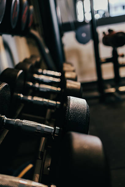 istock Dumbbells arranged on the rack in the gym. 2215729177