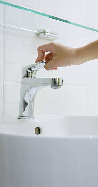 istock asian people turning off faucet 2215731191