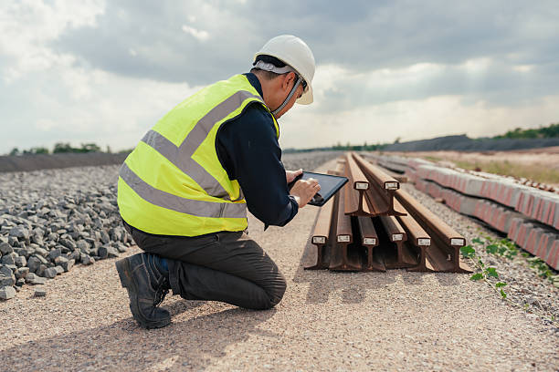 istock Construction engineer recording rail materials with tablet, inspecting steel beams at railway site. 2215732847