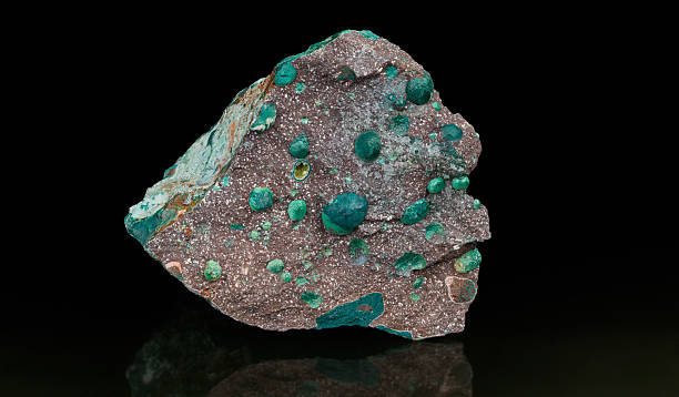 istock Melaphyre extrusive volcanic igneous rock on a black background with reflection 2215734899