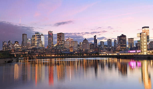 Montreal skyline at night with nice reflections in the St. Lawrence River, Canada