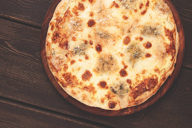 Freshly baked cheese pizza, with a golden crust and bubbling melted cheese, white pizza, on a wooden board, homemade, no people,