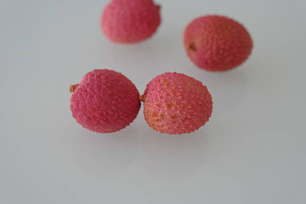 lychee fruit. red lychee fruit on white. lychee is a small tropical fruit from the soapberry family