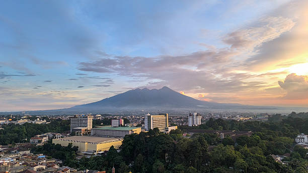 istock Sunrise over a City and Mountain Range 2215749321
