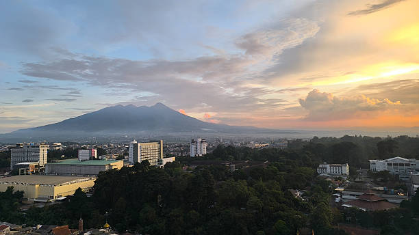 istock Sunset over a city and mountain range 2215749364