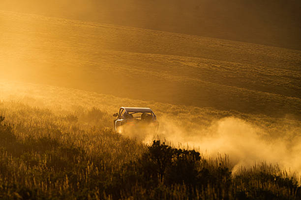 istock Side by Side ATV Riding Fast Kicking up Dust Cloud 2215756041