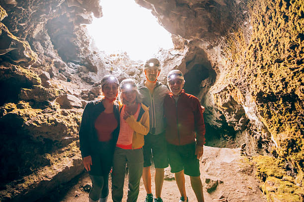 istock Family exploring a lava cave wearing headlamps during an underground excursion 2215757055