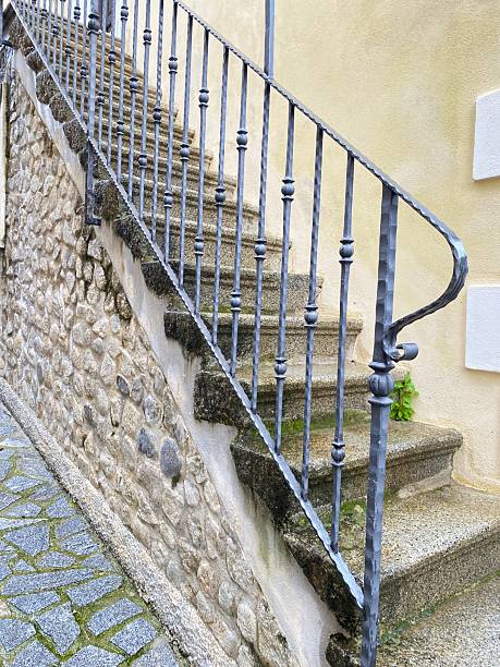 istock Stone staircase with hand-forged iron railings. Natural stone and decorative metalwork. 2215757636