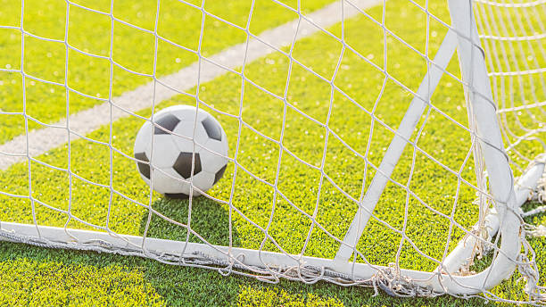 istock Soccer ball in goal 2215759388