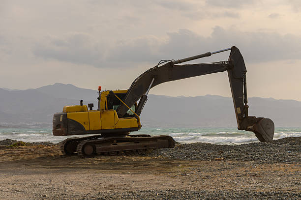 istock Yellow excavator working on the seashore in Cyprus 2215760857