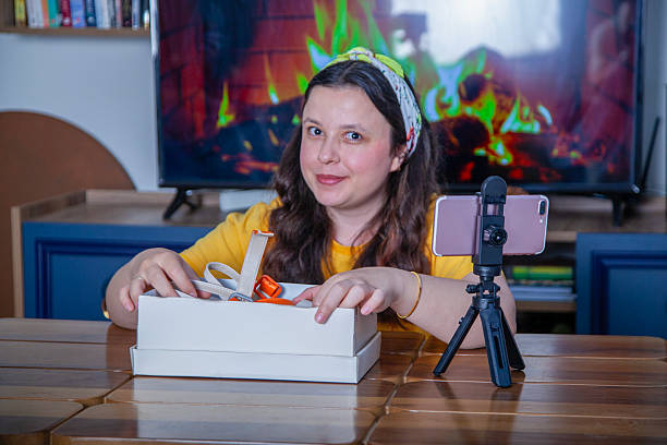 istock Social media influencer recording video while unpacking box at home 2215765727