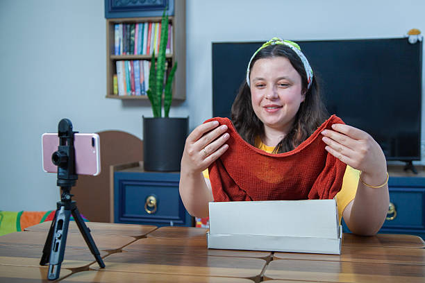 istock Social media influencer recording video while unpacking box at home 2215765878