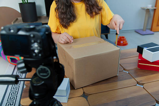 istock Social media influencer recording video while unpacking box at home 2215765959