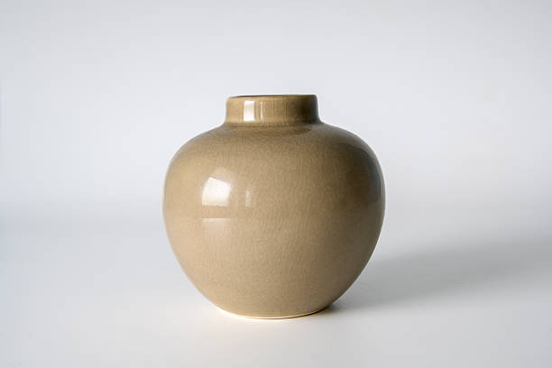 istock A small vase with a brown color sits on a white background. The vase is empty and has a simple design. Concept of calmness and simplicity 2215767453