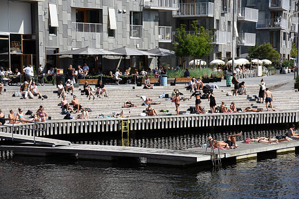 Oslo modern city with several new residential buildings. Captured during a sunny day in summer season with people relaxing at the beautiful Oslo Fjord.