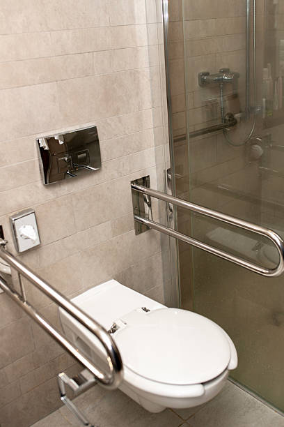 istock Accessible Toilet with Safety Grab Bars in Modern Hotel Bathroom 2215775797