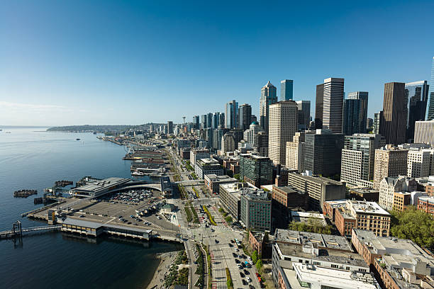 Aerial shot of Downtoen Seattle on a sunny day in spring, taken from above Belltown and looking north along the waterfront.\n\nAuthorization was obtained from the FAA for this operation in restricted airspace.
